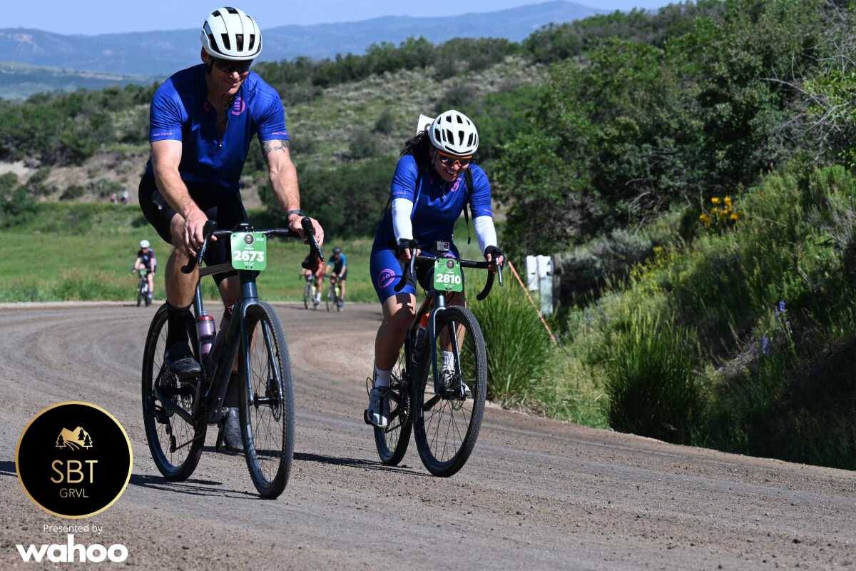 Cinthia (PS Student)  & Eddie Durrell (Donor & Volunteer) riding the 2025 SBT GRVL Race side by side 
