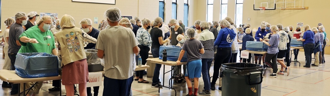 Hardworking, never-give-up volunteers packing meals for Haitian school children.