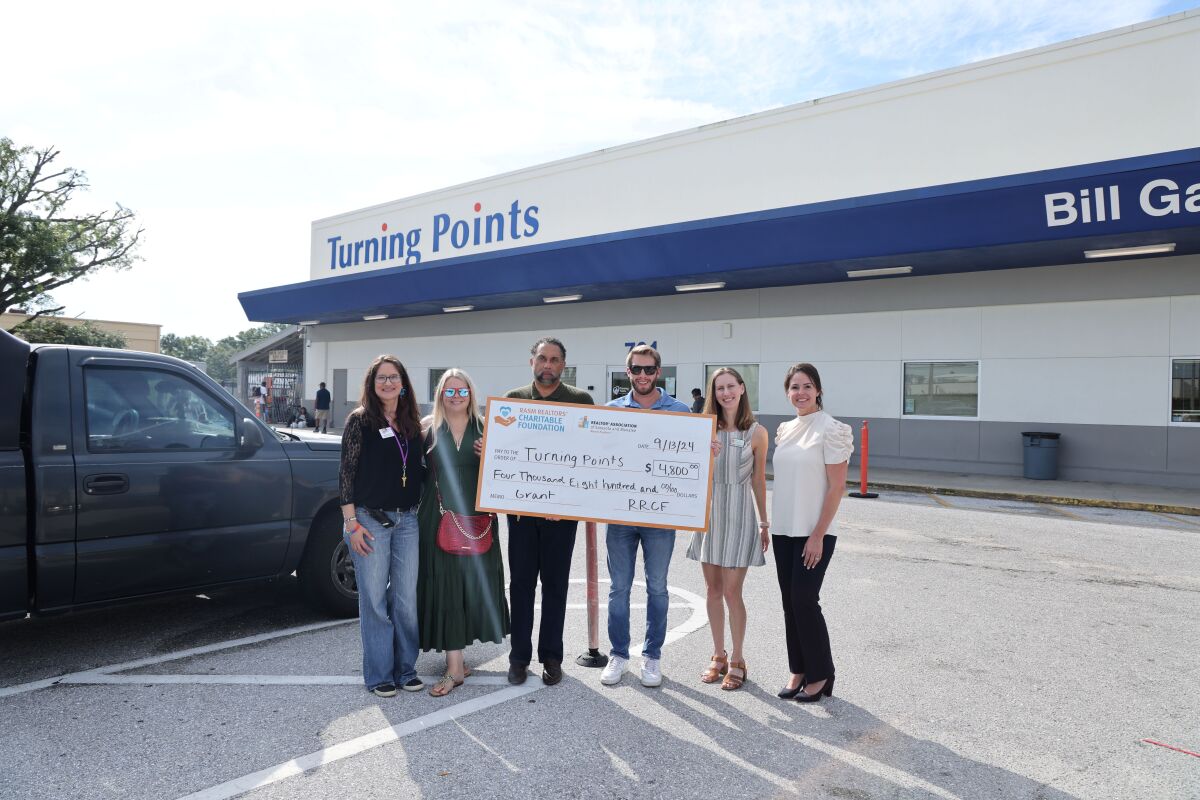 The RRCF Grant Task Force awards a $4,500 check to Turning Points