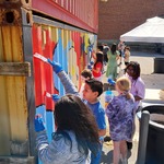 Students from Luff Elementary painting a student deigned mural at Englewood Arts