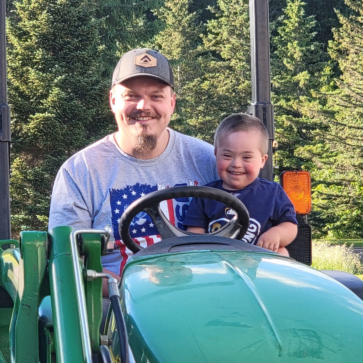 Ashton and Dad(Cuyler) on grandpa's tractor