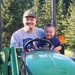 Ashton and Dad(Cuyler) on grandpa's tractor