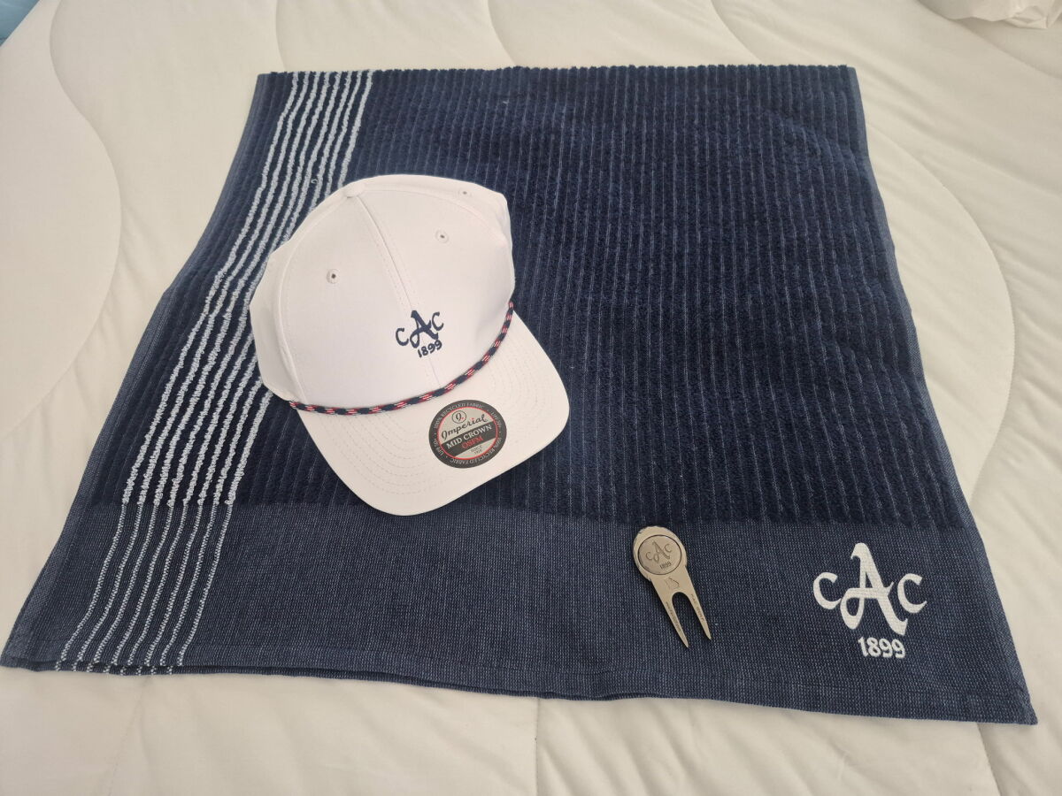 August Country Club Golf Package: Hat, golf towel, divot tool with removable ball marker, valued over $100.00.
