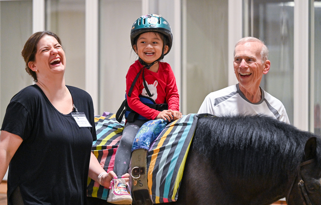 Miss Nikki and volunteer Steve with a kiddo