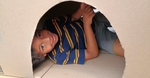 A refugee child in a fort built during a community outreach day