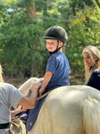 Harry at hippotherapy, riding Apollo the pony.