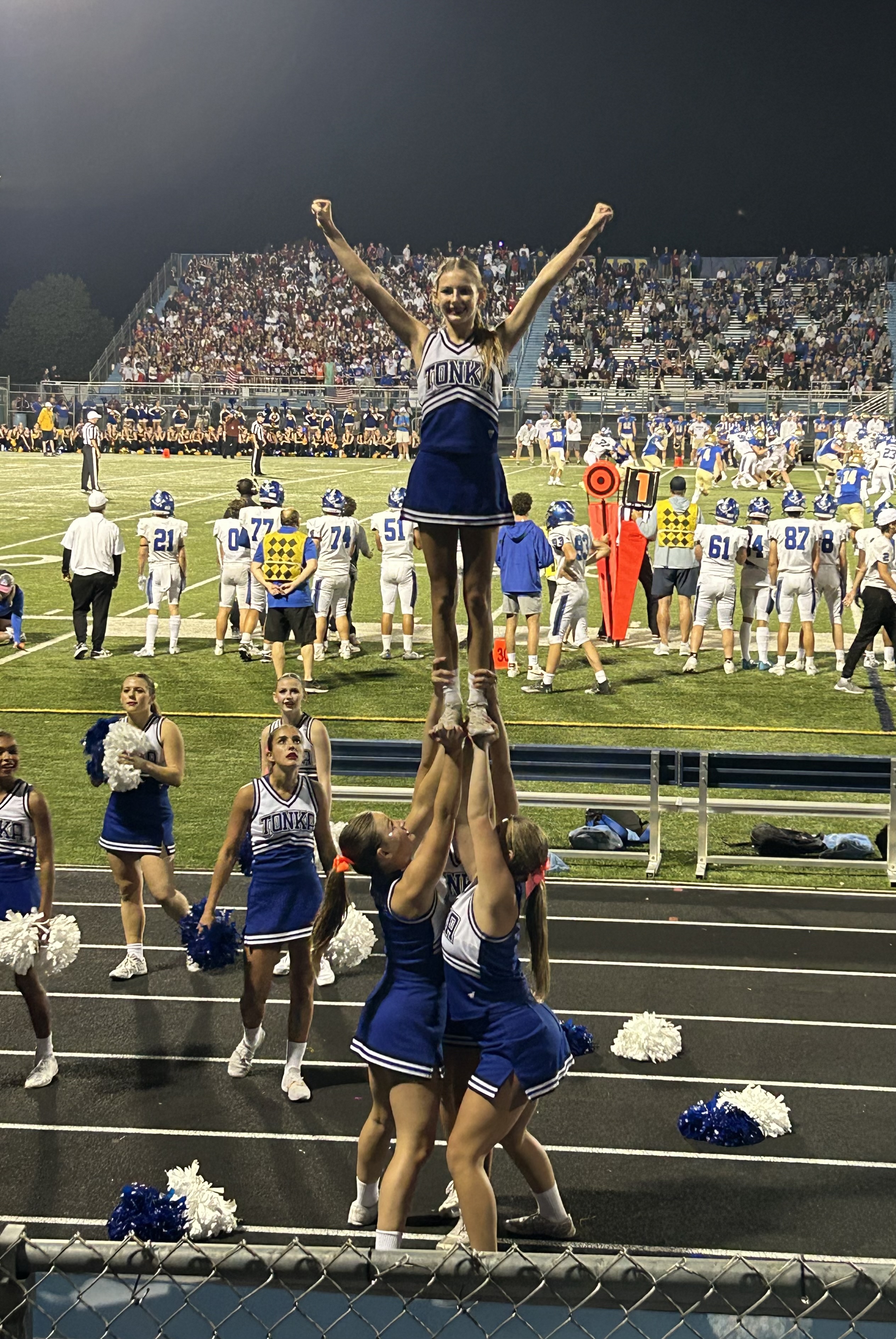 Stunting at a home game. (Grace is on the bottom left)
