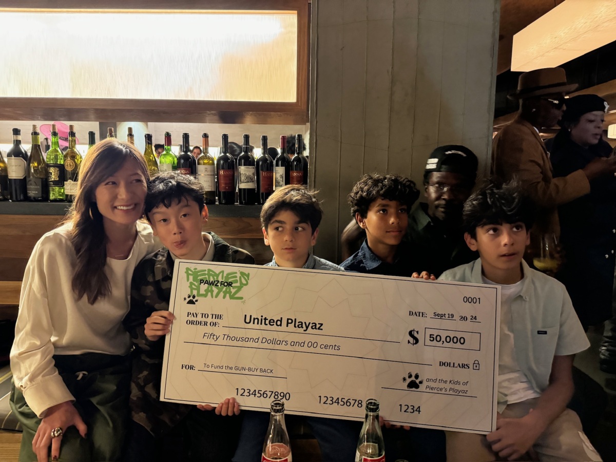 Lesley and friends presenting a check for $50,000 to United Playaz for a gun buy back. 