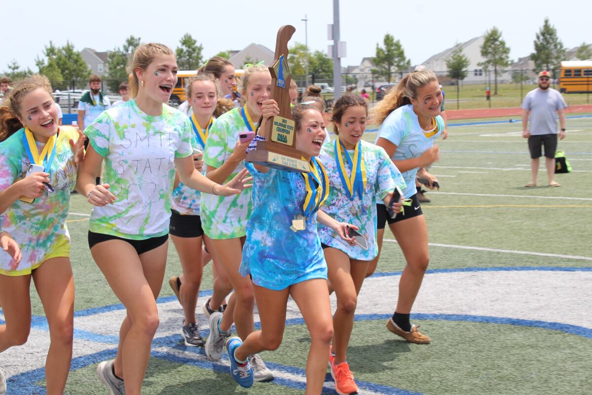Tiffany Herrera leading the girls' to their 2021 State Title victory lap.