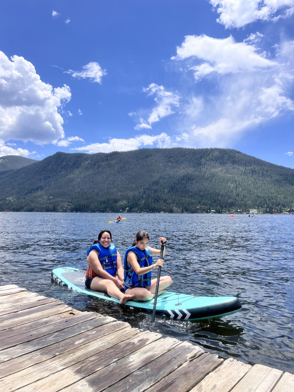 Highschoolers, Citlali & Anna, paddle boarding on a summer camp