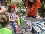 Kids thoughtfully tie-dying shirts at Family Day