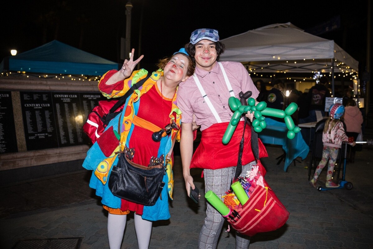 Silly Sally and a team member at the donation booth, where funds raised through face painting and balloon activities help support the Waymakers Huntington Beach Youth Shelter.