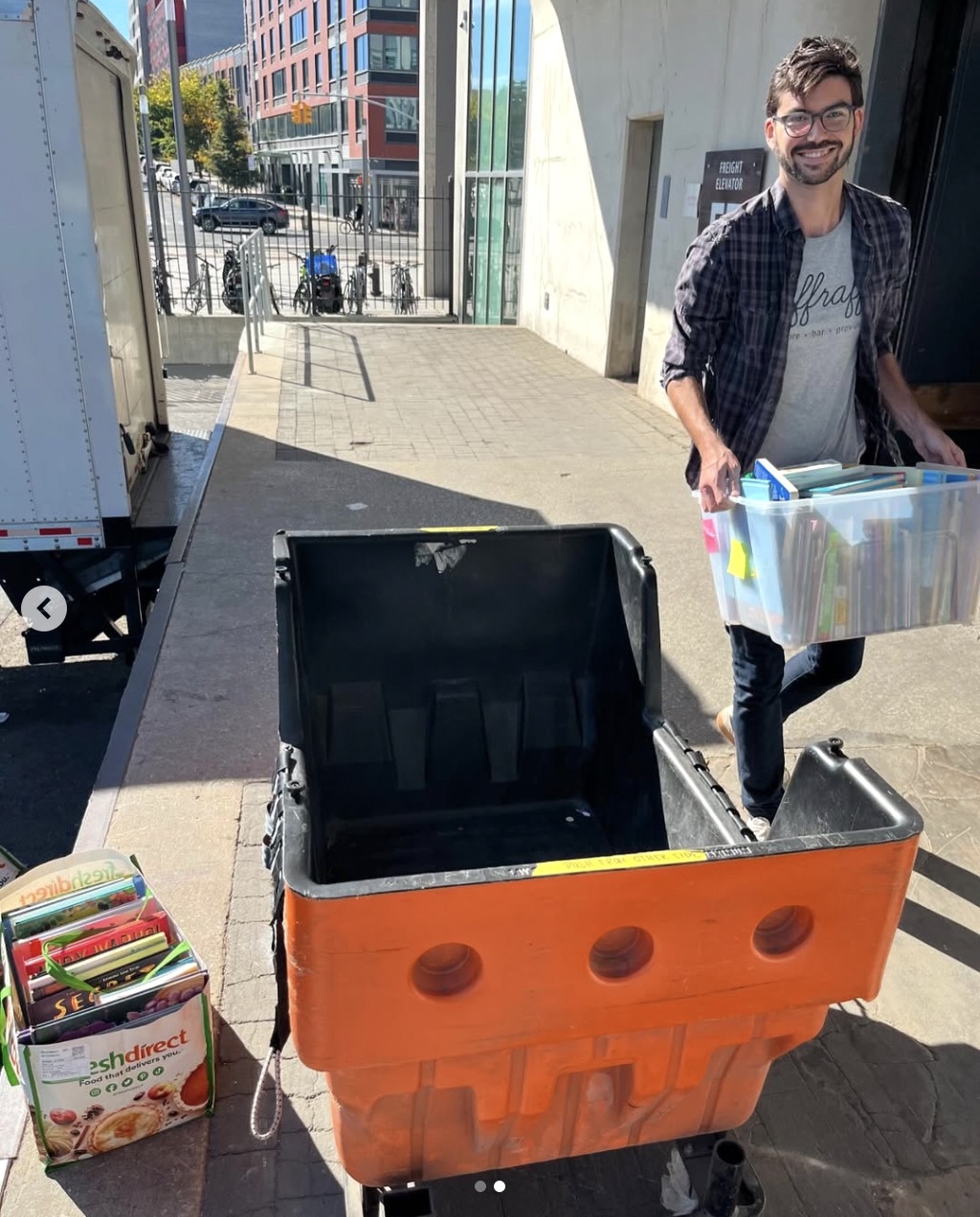 Me lugging books for Brooklyn Book Bodega - I also suggest you volunteer in addition to making a donation!