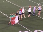 Tess and other athletes carrying the WDSRA banner at state