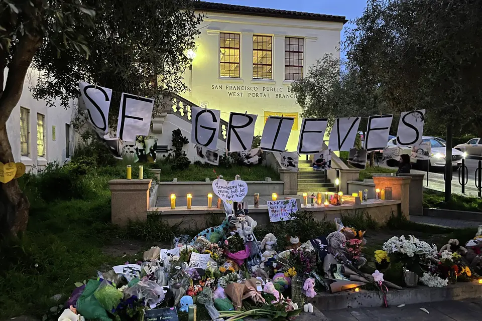 Flower bouquets and stuffed animals were placed on a sidewalk in San Francisco’s West Portal neighborhood.