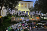 Flower bouquets and stuffed animals were placed on a sidewalk in San Francisco’s West Portal neighborhood.
