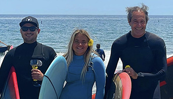 World Surfing Champion and this year's Co-Chair Shaun Tomson with participants at last year’s Paddle Out Party. 