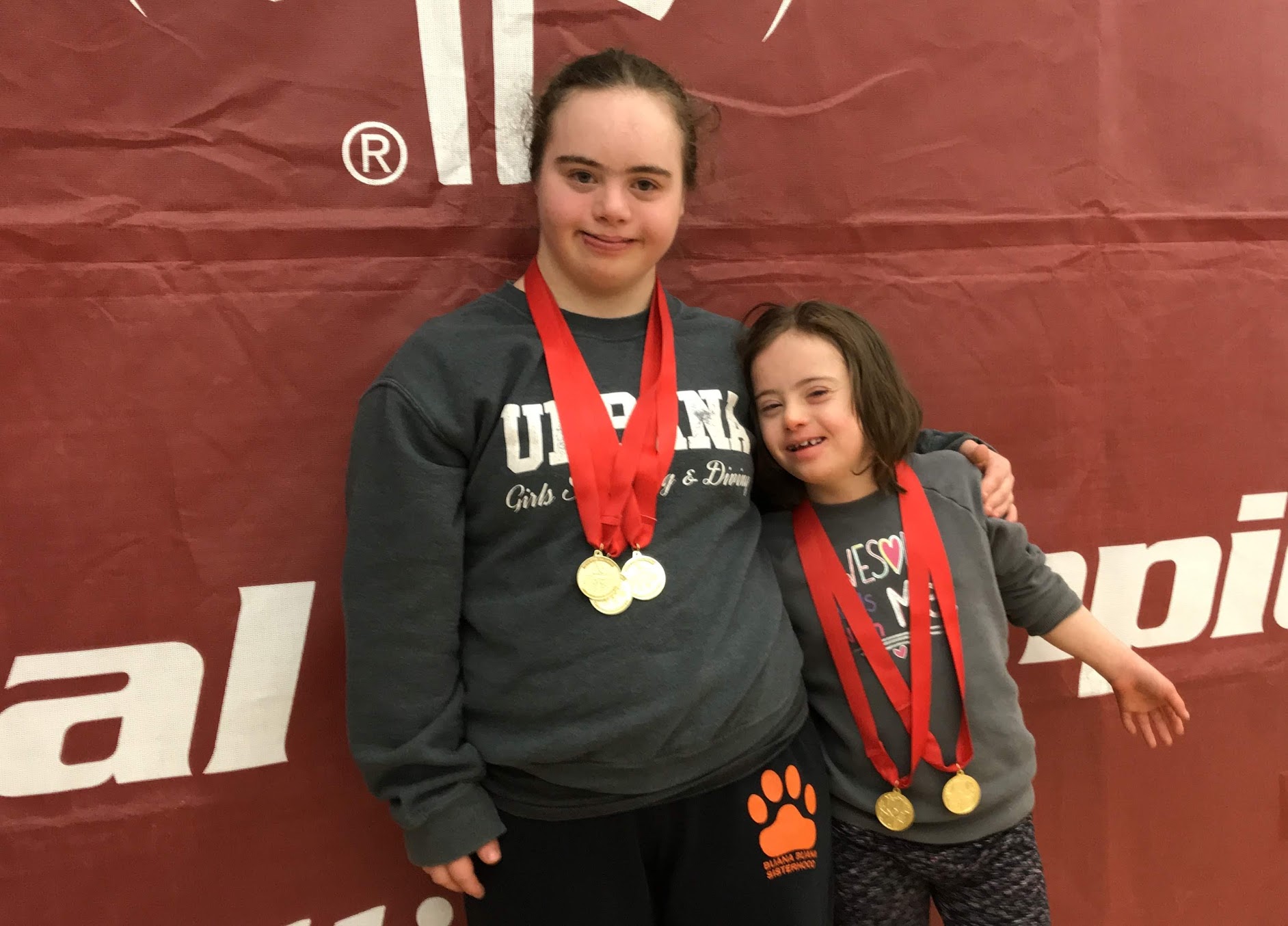 Alison and Josie rocking their swimming medals