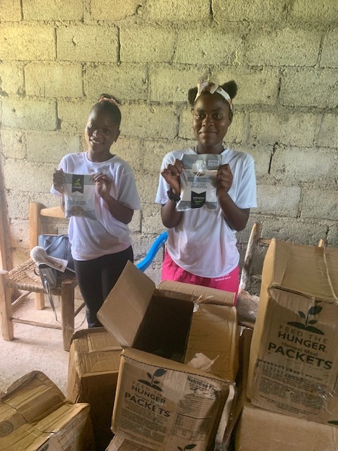 Children receive food in Northern Haiti